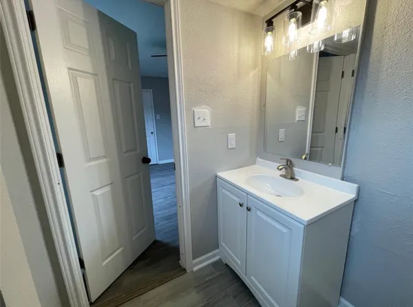 a bathroom with a sink a mirror and a shower