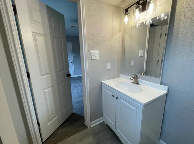 a bathroom with a sink a mirror and a shower