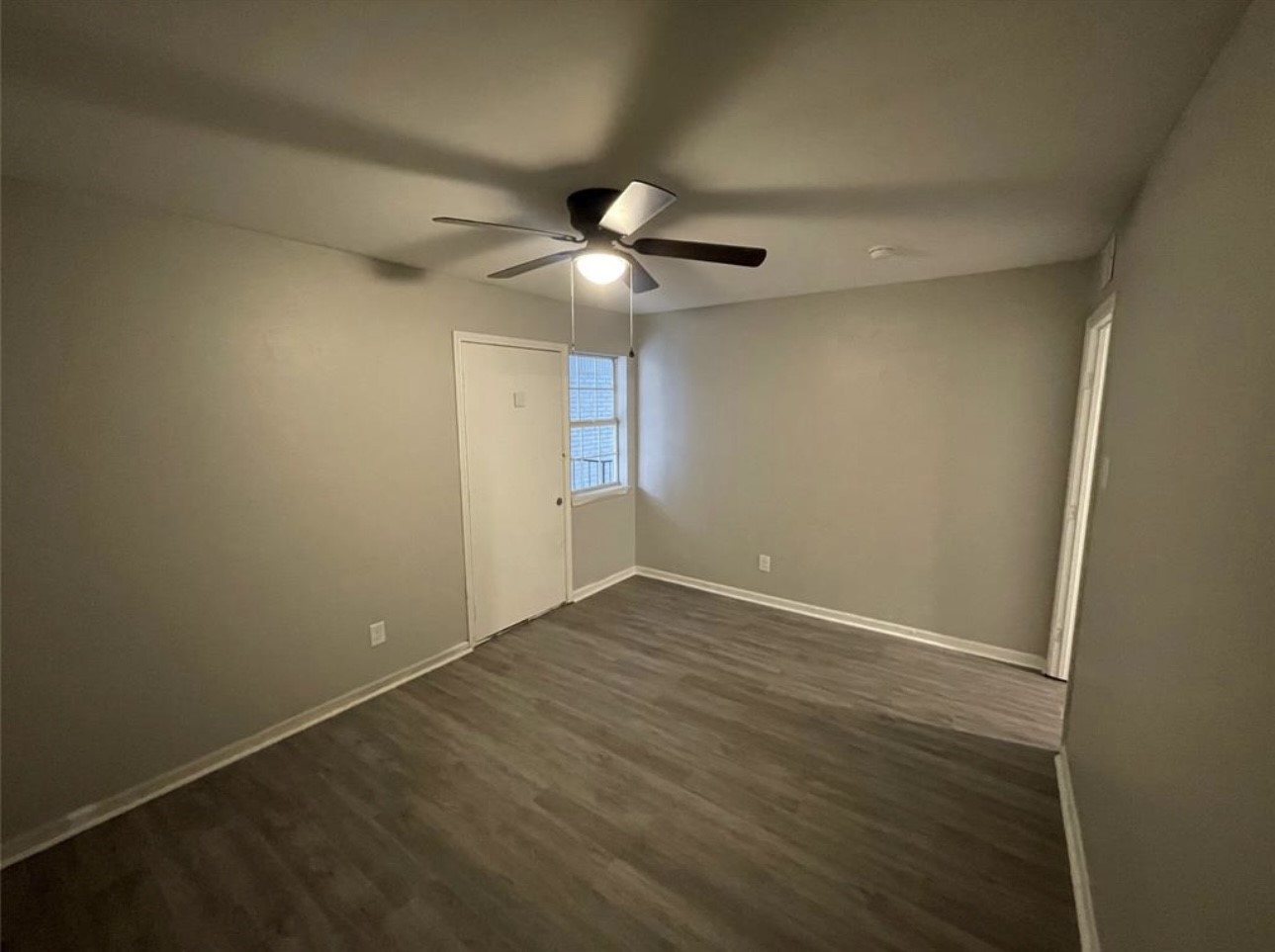 9711 Linkmeadow Lane, Unit 10 Houston, TX 77025 - Photo 20 of 27 an empty room with a window and a fan