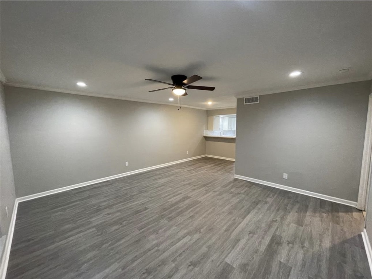 9711 Linkmeadow Lane, Unit 10 Houston, TX 77025 - Photo 6 of 27 an empty room with wooden floor and windows