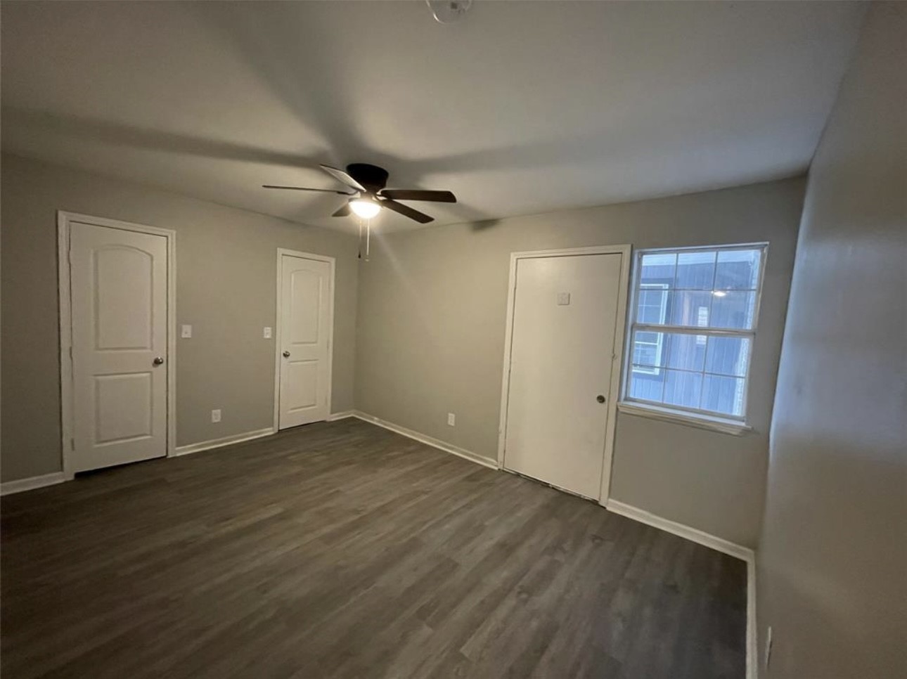 9711 Linkmeadow Lane, Unit 10 Houston, TX 77025 - Photo 10 of 27 an empty room with wooden floor closet and windows