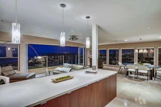 a kitchen with stainless steel appliances kitchen island granite countertop a table and chairs in it
