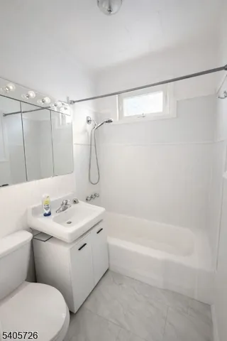 a view of a livingroom with a ceiling fan and window