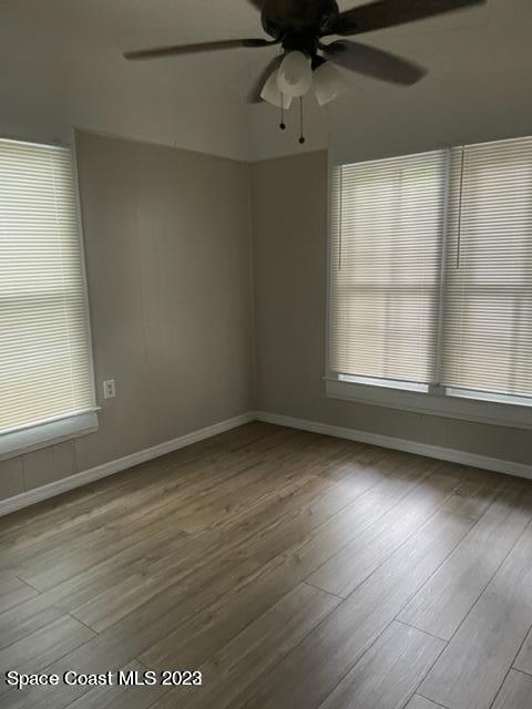 2206 Irwin Street Melbourne, FL 32901 - Photo 3 of 13 an empty room with wooden floor and windows