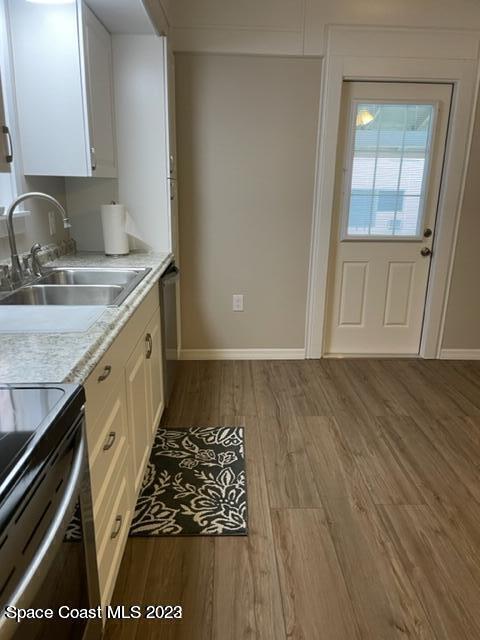 2206 Irwin Street Melbourne, FL 32901 - Photo 6 of 13 a kitchen with wooden cabinets stove and sink
