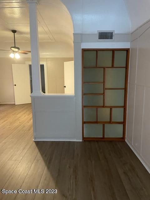 2206 Irwin Street Melbourne, FL 32901 - Photo 9 of 13 an empty room with wooden floor and cabinet