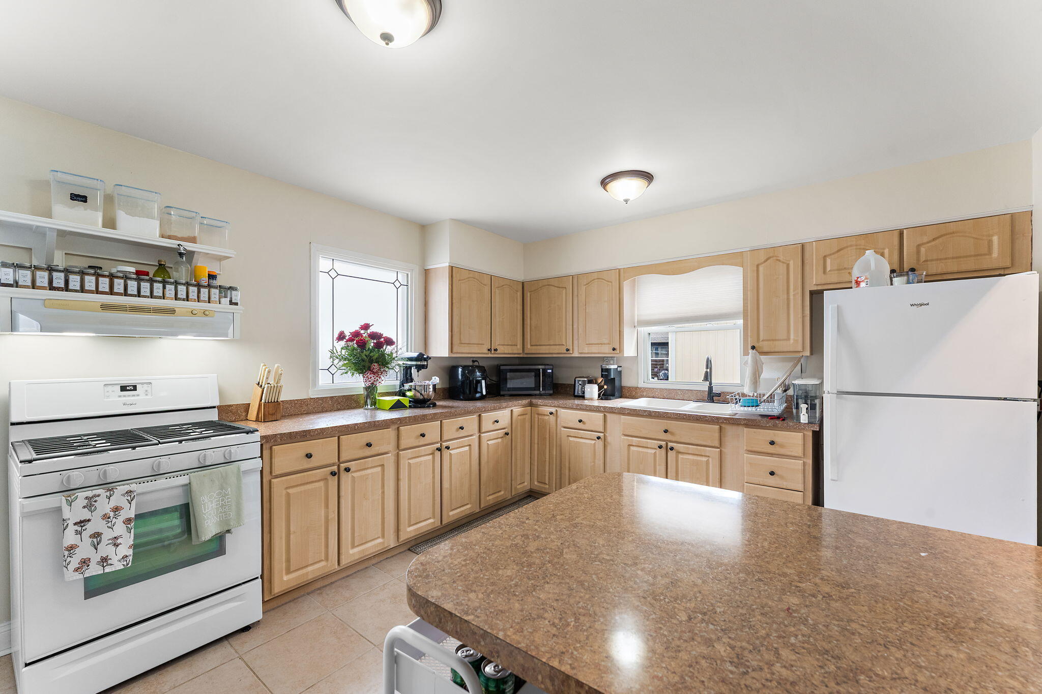 324 Maple Street Crown Point, IN 46307 - Photo 5 of 13 a kitchen with a stove a sink and a refrigerator