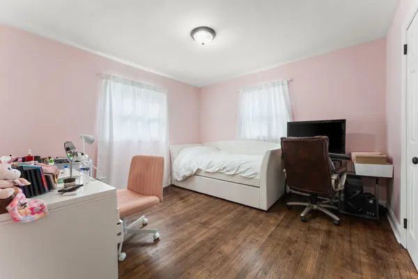 a bedroom with a bed and a chair
