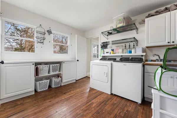 a kitchen with stainless steel appliances a wooden floor and cabinets