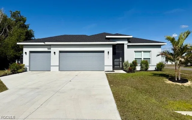 a front view of a house with a yard and garage