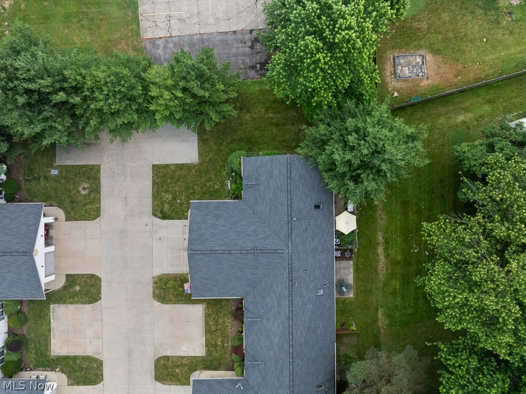 808 Ryan Road, Unit 14 Medina, OH 44256 - Photo 40 of 40 Aerial perspective showcasing a property with a dark shingle roof, extensive green lawn, mature trees, and a concrete patio