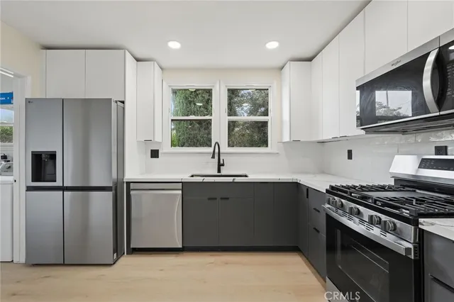 a kitchen with a sink stove and microwave