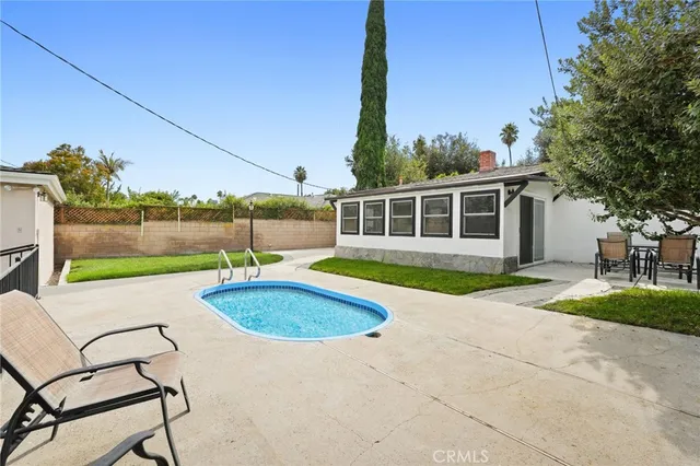 a view of a house with a yard and sitting area