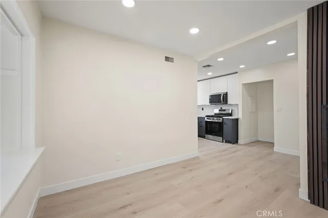 a view of a kitchen with stainless steel appliances a refrigerator and counter top