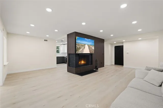 a large room with furniture and a fireplace