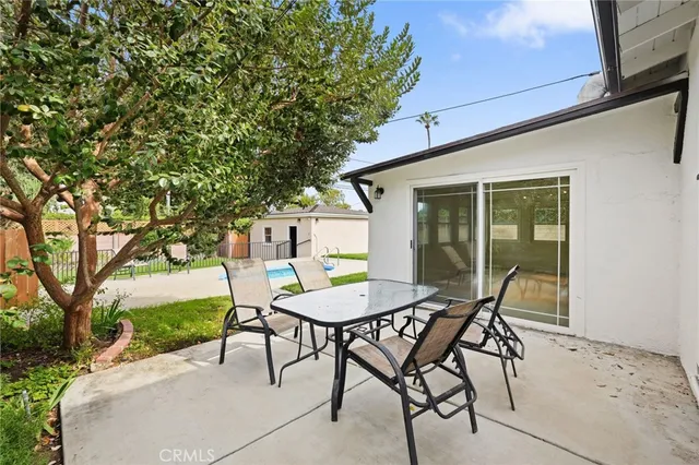 a view of a house with a yard and potted plants
