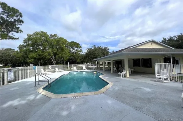 a view of a house with swimming pool and sitting area