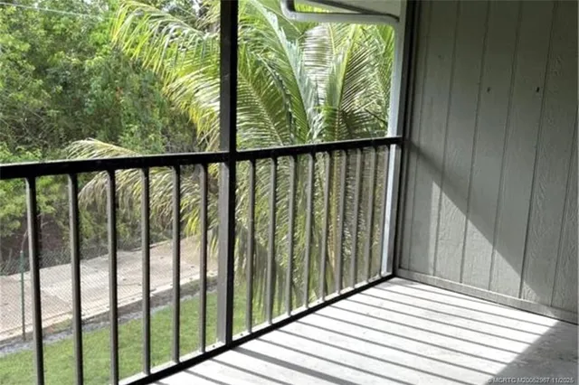 a view of balcony with wooden floor