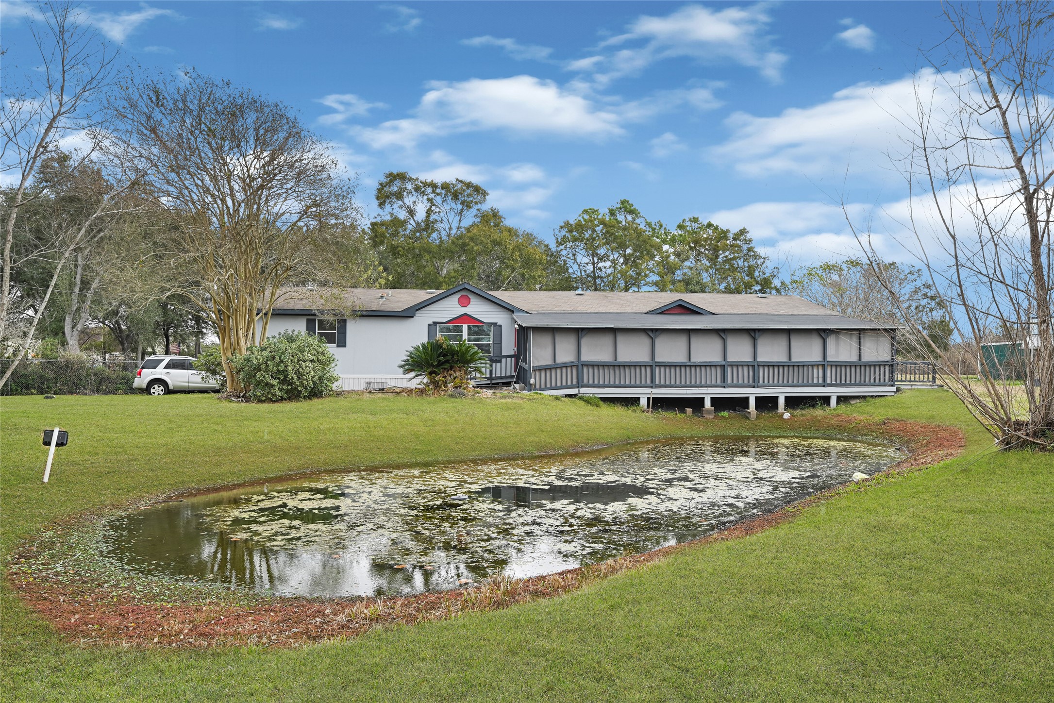 a view of house with garden space and swimming pool