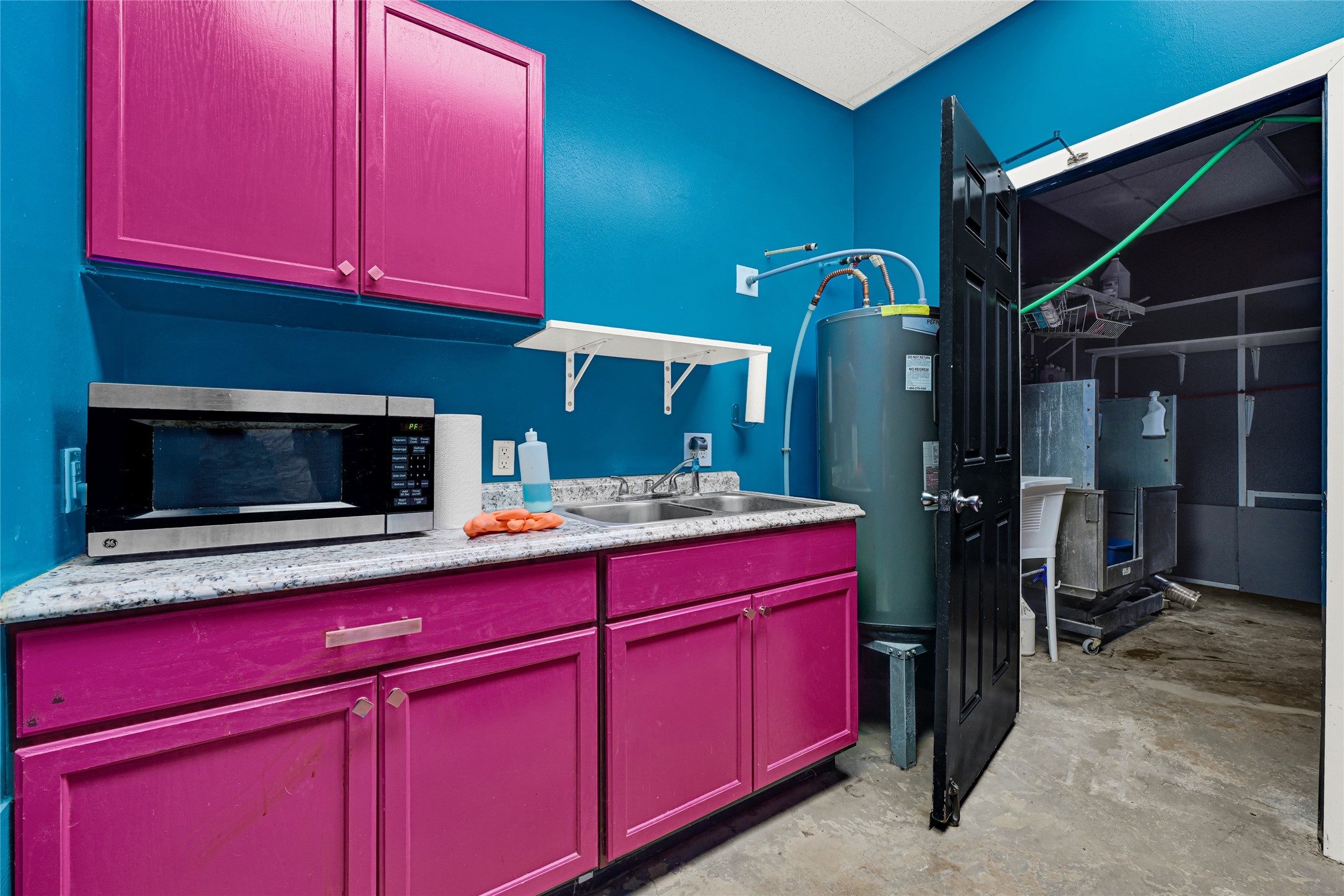 3725 Allen Road Pearland, TX 77584 - Photo 37 of 43 a kitchen with a sink cabinets and microwave