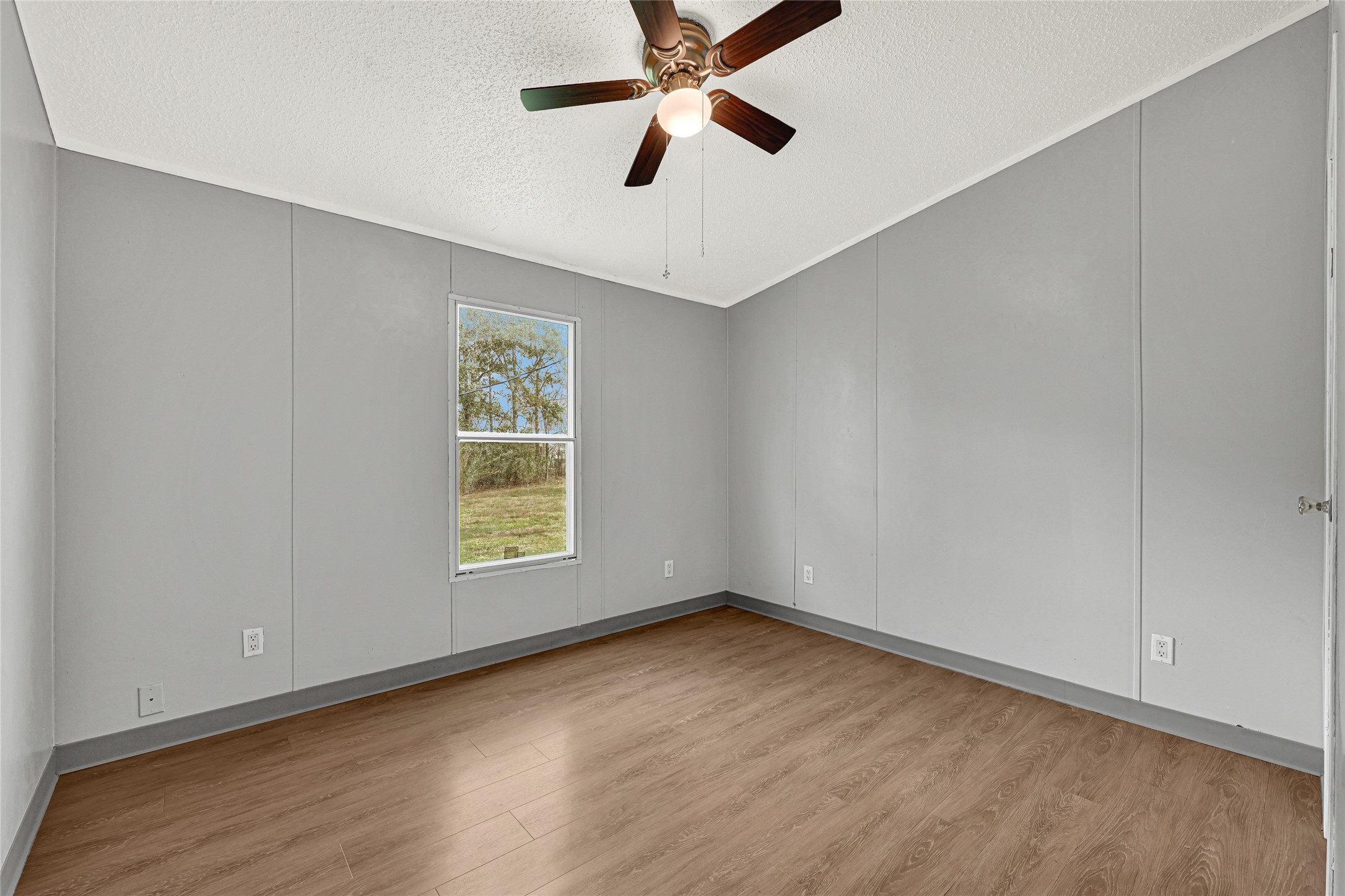 3725 Allen Road Pearland, TX 77584 - Photo 6 of 43 wooden floor in an empty room with a window and a ceiling fan