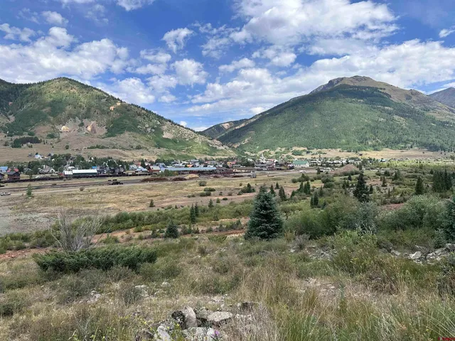 a view of a town with mountains in the background