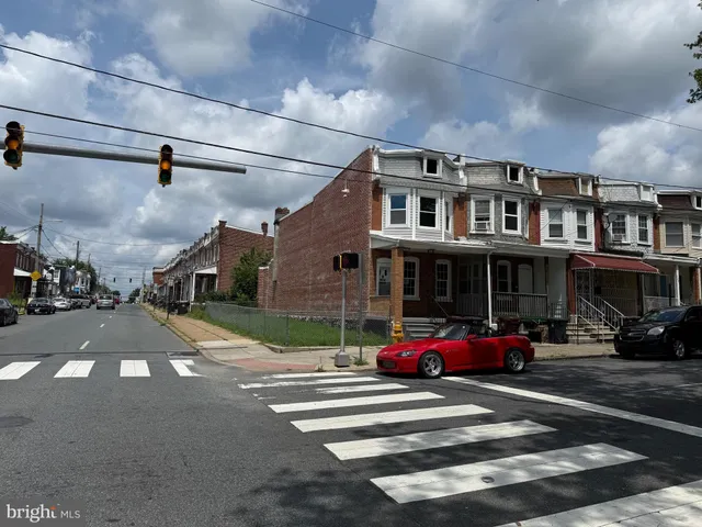 a car parked in front of a white house