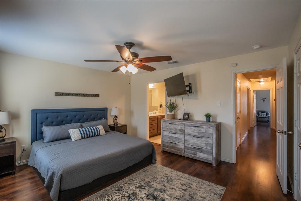 6801 Sandshell Boulevard Fort Worth, TX 76137 - Photo 12 of 28 a bedroom with a bed and wooden floor