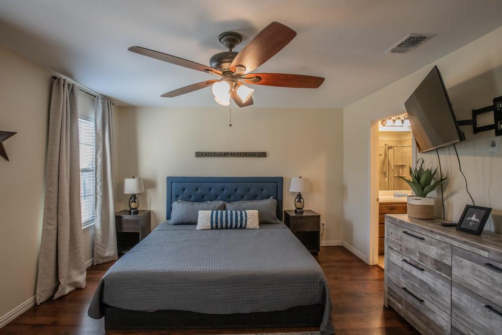 6801 Sandshell Boulevard Fort Worth, TX 76137 - Photo 14 of 28 a bedroom with a bed and a flat screen tv