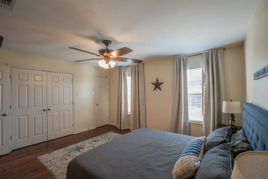 6801 Sandshell Boulevard Fort Worth, TX 76137 - Photo 15 of 28 a bedroom with a bed and a chandelier