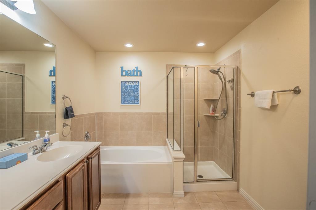 6801 Sandshell Boulevard Fort Worth, TX 76137 - Photo 16 of 28 a bathroom with a double vanity sink mirror and shower