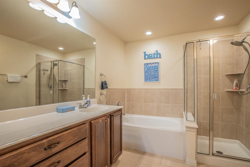 6801 Sandshell Boulevard Fort Worth, TX 76137 - Photo 17 of 28 a bathroom with a double vanity sink toilet mirror and bathtub