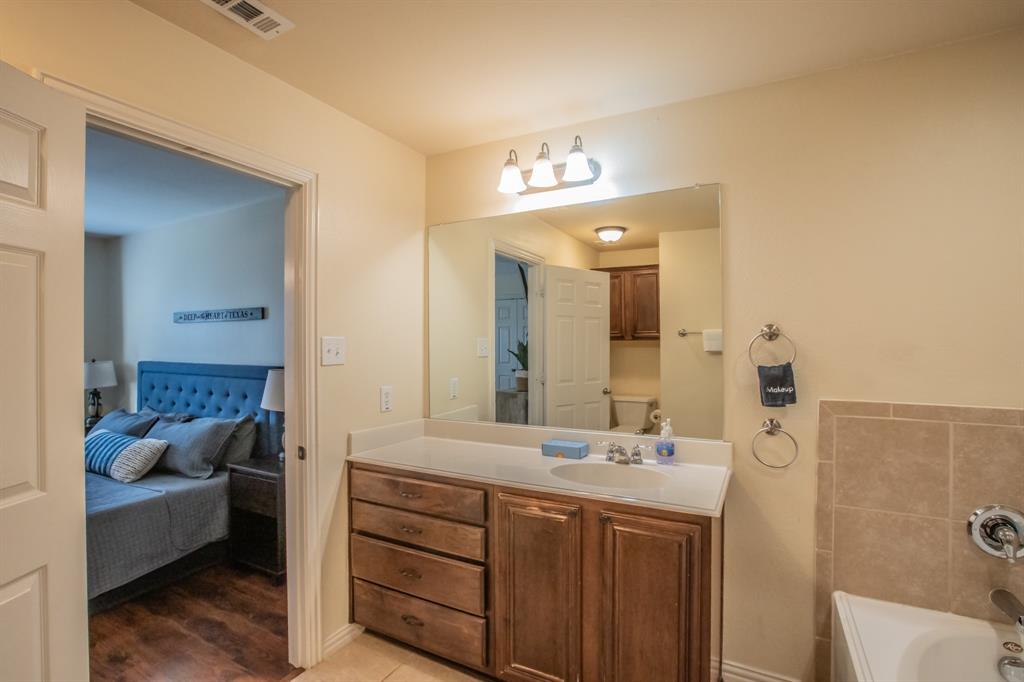 6801 Sandshell Boulevard Fort Worth, TX 76137 - Photo 18 of 28 a bathroom with a double vanity sink and a mirror