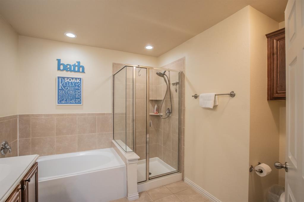 6801 Sandshell Boulevard Fort Worth, TX 76137 - Photo 19 of 28 a bathroom with a shower and a tub