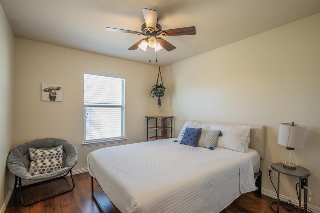 6801 Sandshell Boulevard Fort Worth, TX 76137 - Photo 24 of 28 a bedroom with a bed and a couch