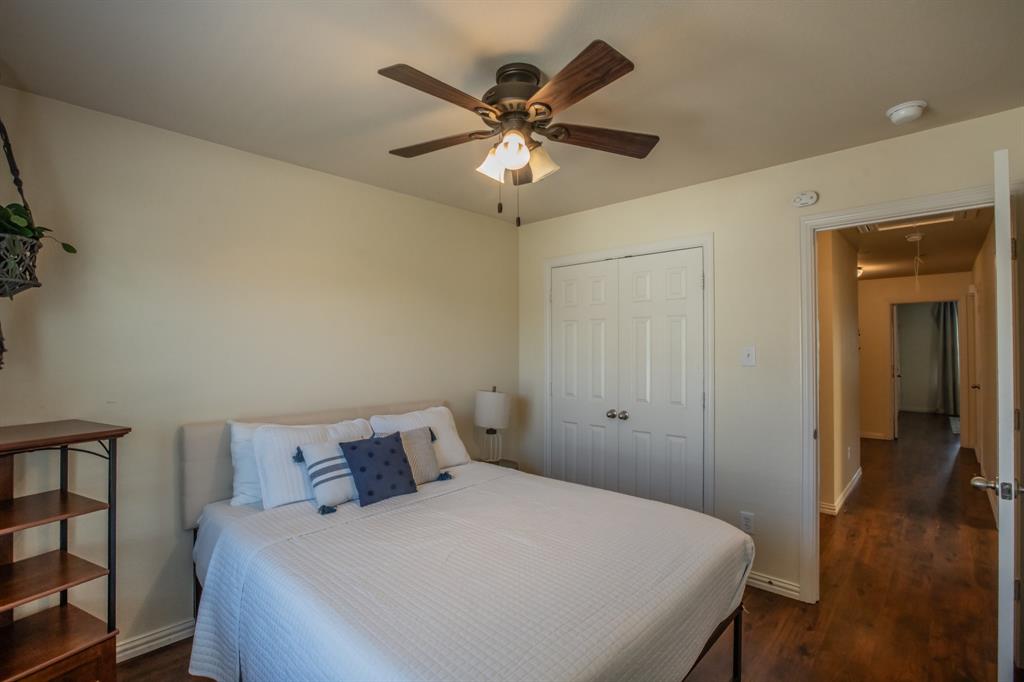 6801 Sandshell Boulevard Fort Worth, TX 76137 - Photo 26 of 28 a bedroom with a bed and a ceiling fan