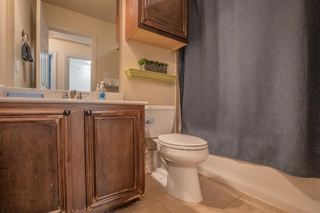 6801 Sandshell Boulevard Fort Worth, TX 76137 - Photo 27 of 28 a bathroom with a sink a toilet and shower