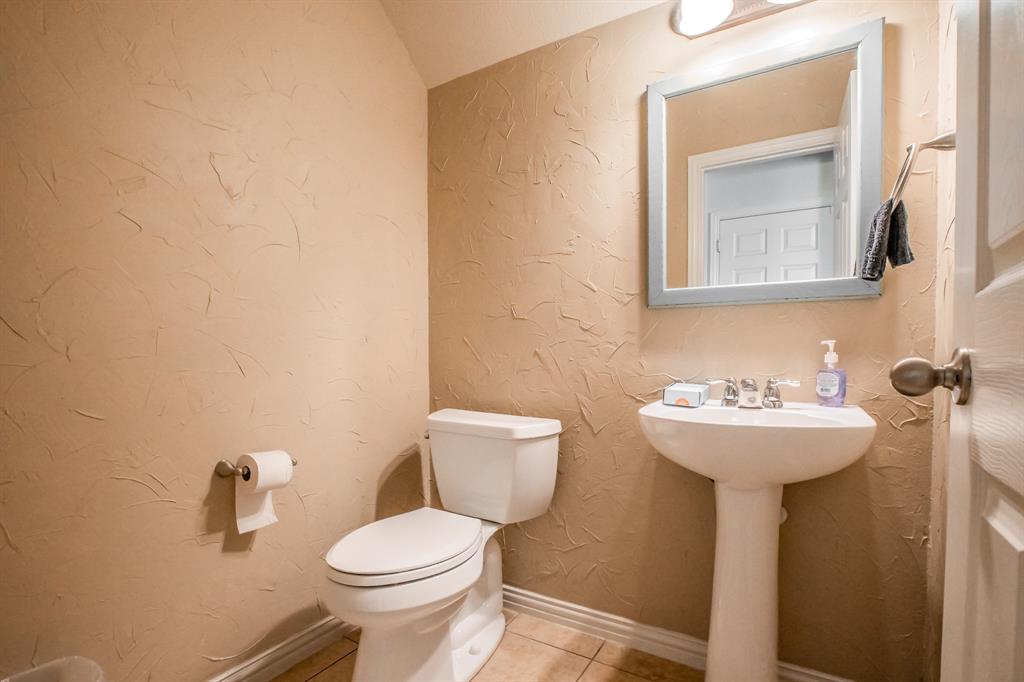 6801 Sandshell Boulevard Fort Worth, TX 76137 - Photo 28 of 28 a bathroom with a sink mirror and toilet