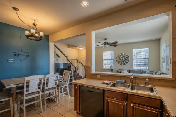 a kitchen with a table chairs sink and cabinets