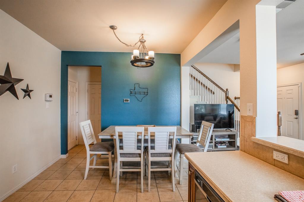 6801 Sandshell Boulevard Fort Worth, TX 76137 - Photo 9 of 28 a view of a dining room with furniture and a chandelier