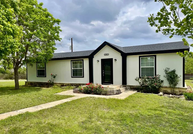 a front view of a house with a yard