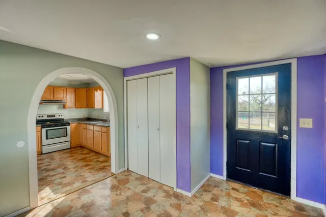 a view of a kitchen with a stove and cabinet