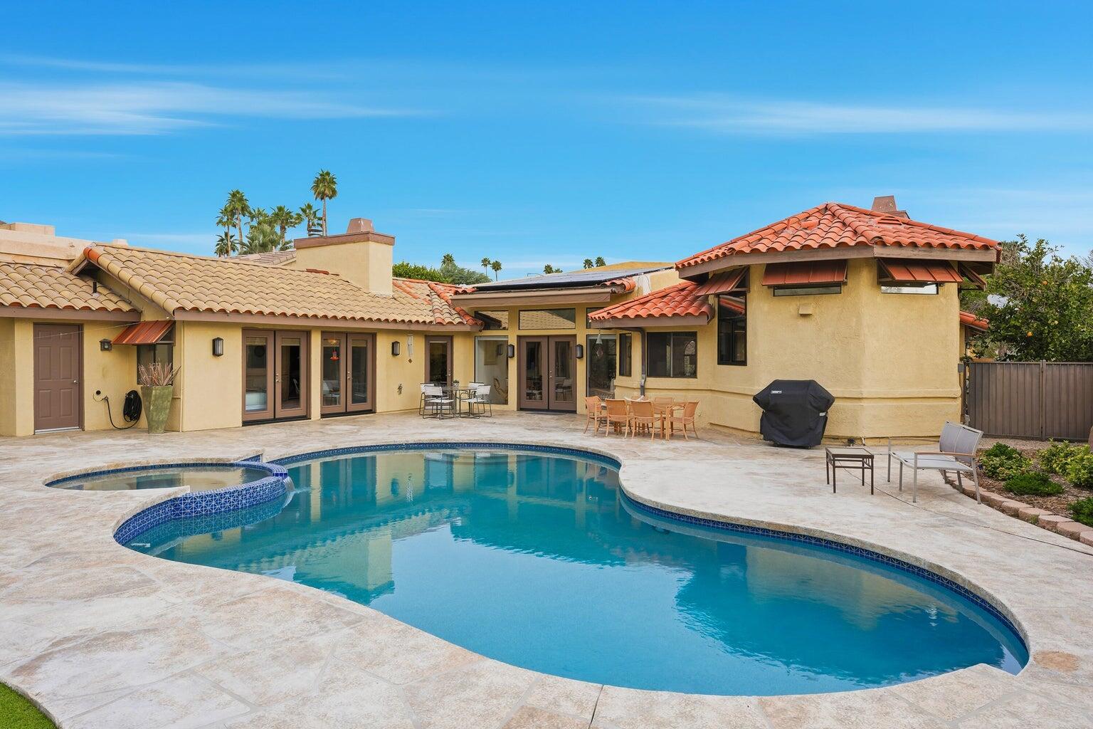 10 Venus Drive Rancho Mirage, CA 92270 - Photo 14 of 32 a view of a house with pool and chairs