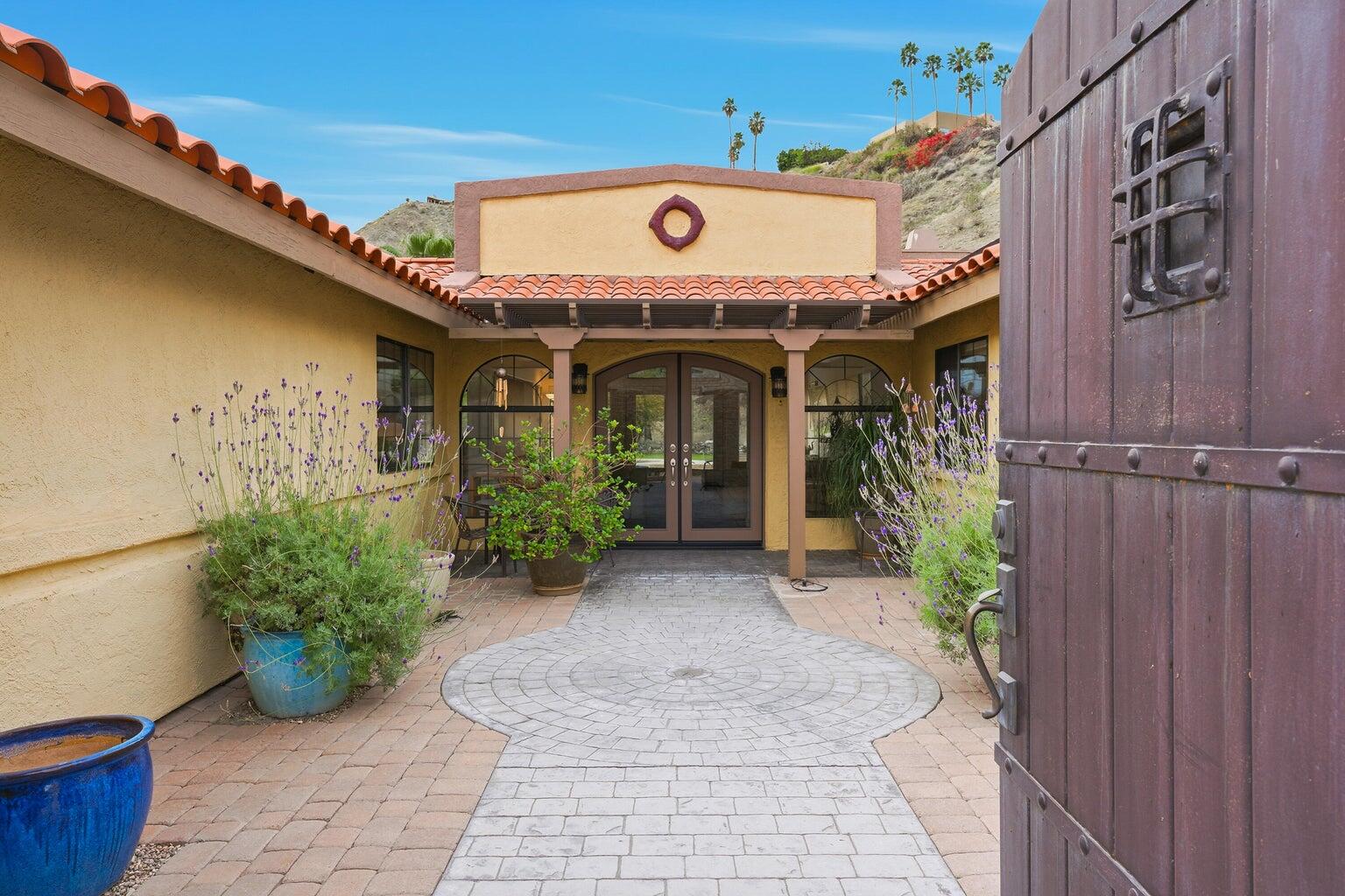 10 Venus Drive Rancho Mirage, CA 92270 - Photo 16 of 32 a front view of a house with garden