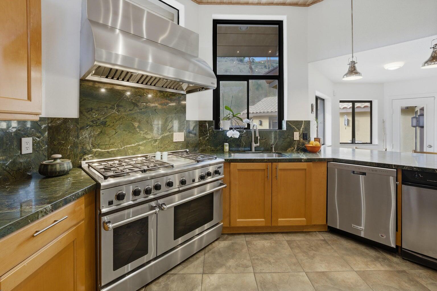 10 Venus Drive Rancho Mirage, CA 92270 - Photo 20 of 32 a kitchen with stainless steel appliances granite countertop a stove a sink and a microwave