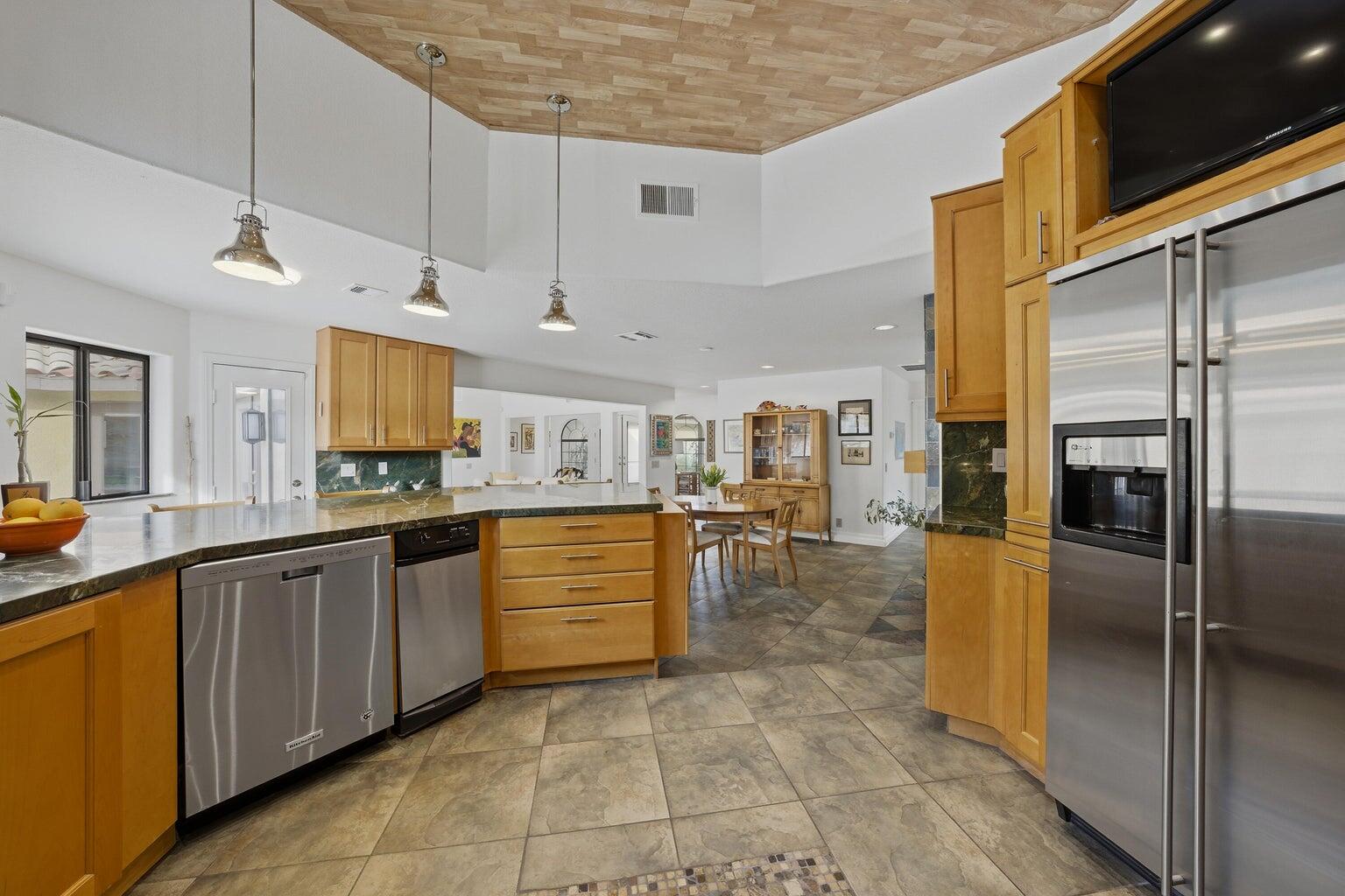 10 Venus Drive Rancho Mirage, CA 92270 - Photo 21 of 32 a kitchen with stainless steel appliances granite countertop a refrigerator and a sink