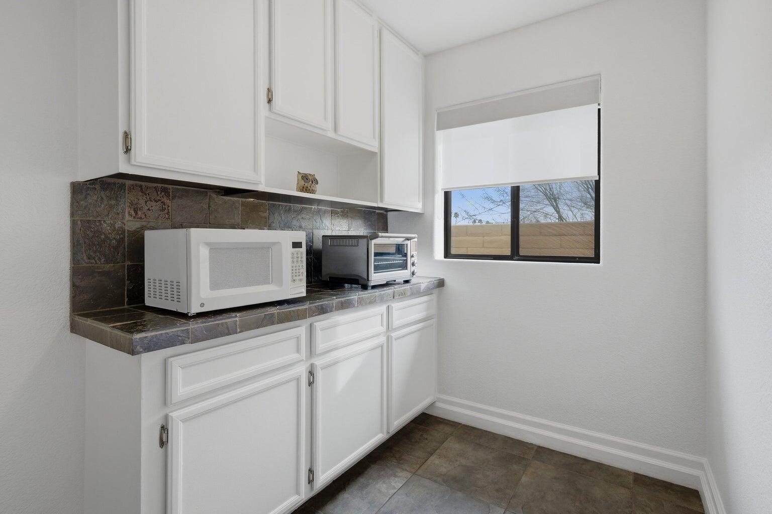 10 Venus Drive Rancho Mirage, CA 92270 - Photo 22 of 32 a kitchen with stainless steel appliances white cabinets and a sink