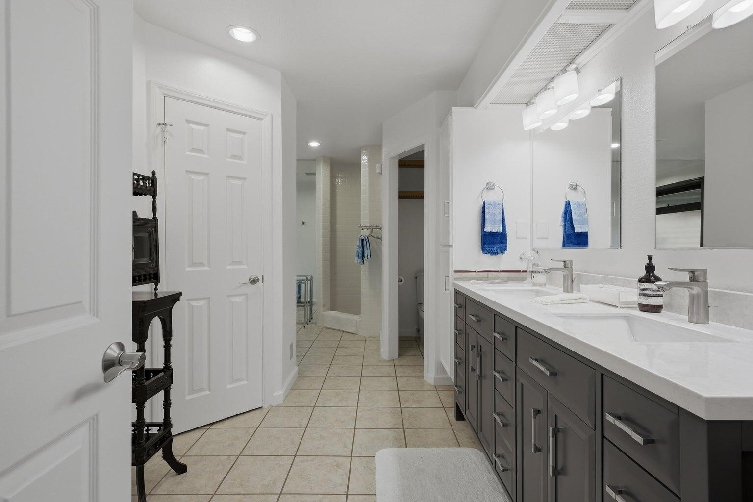 10 Venus Drive Rancho Mirage, CA 92270 - Photo 25 of 32 a spacious bathroom with a granite countertop sink a mirror and a shower