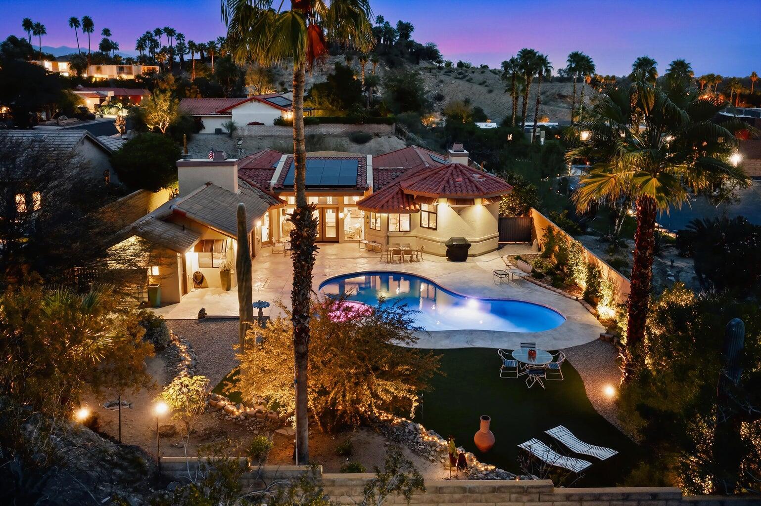 10 Venus Drive Rancho Mirage, CA 92270 - Photo 31 of 32 a view of a building with swimming pool and outdoor seating