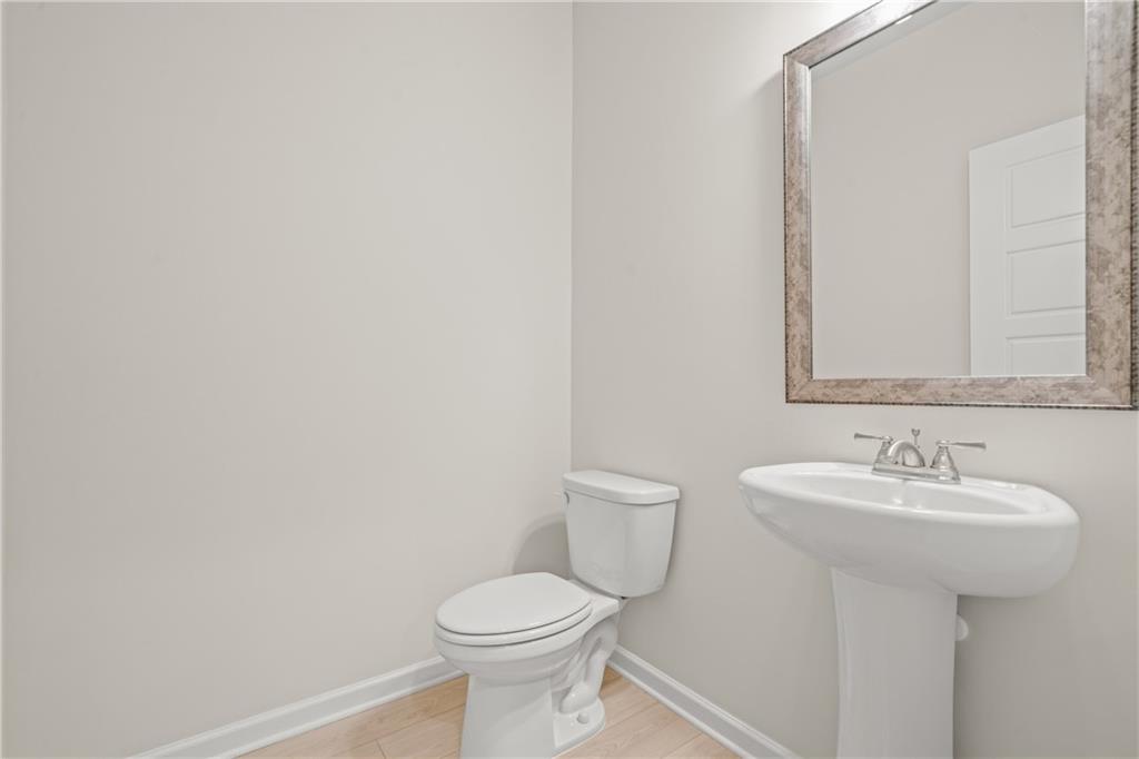 32 Station Overlook Way Auburn, GA 30011 - Photo 19 of 38 a bathroom with a sink a toilet and mirror